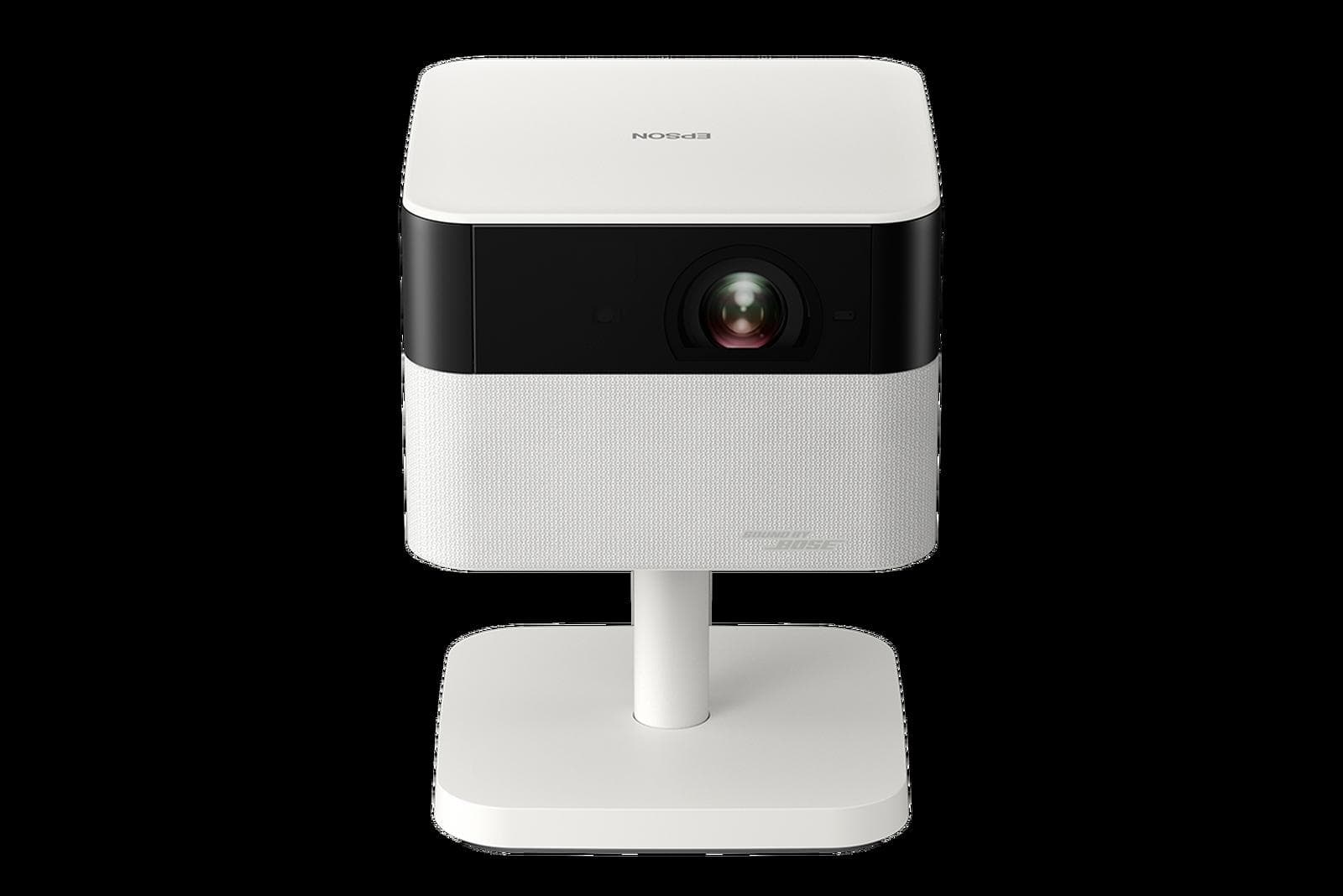 Epson EF-71 Lifestudio Flex in Diamond White, shot square-on: cube-shaped projector body with the lens in a black band, Sound by Bose fabric grille below, on its pedestal stand