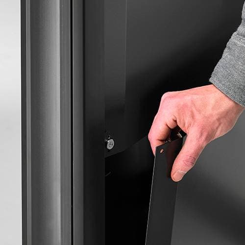 Close-up of a hand lifting one of the XPA1U magnetic rear covers away from the cart column.