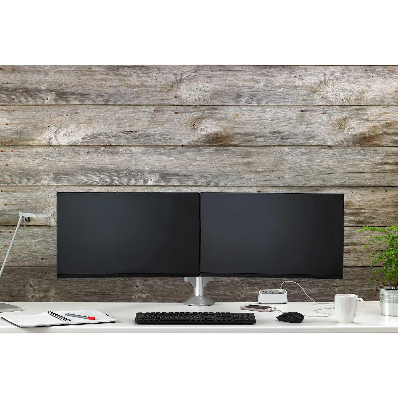 Desk photograph of two monitors side by side on a Chief Kontour KX column desk mount. A lifestyle image for the KX arm range.