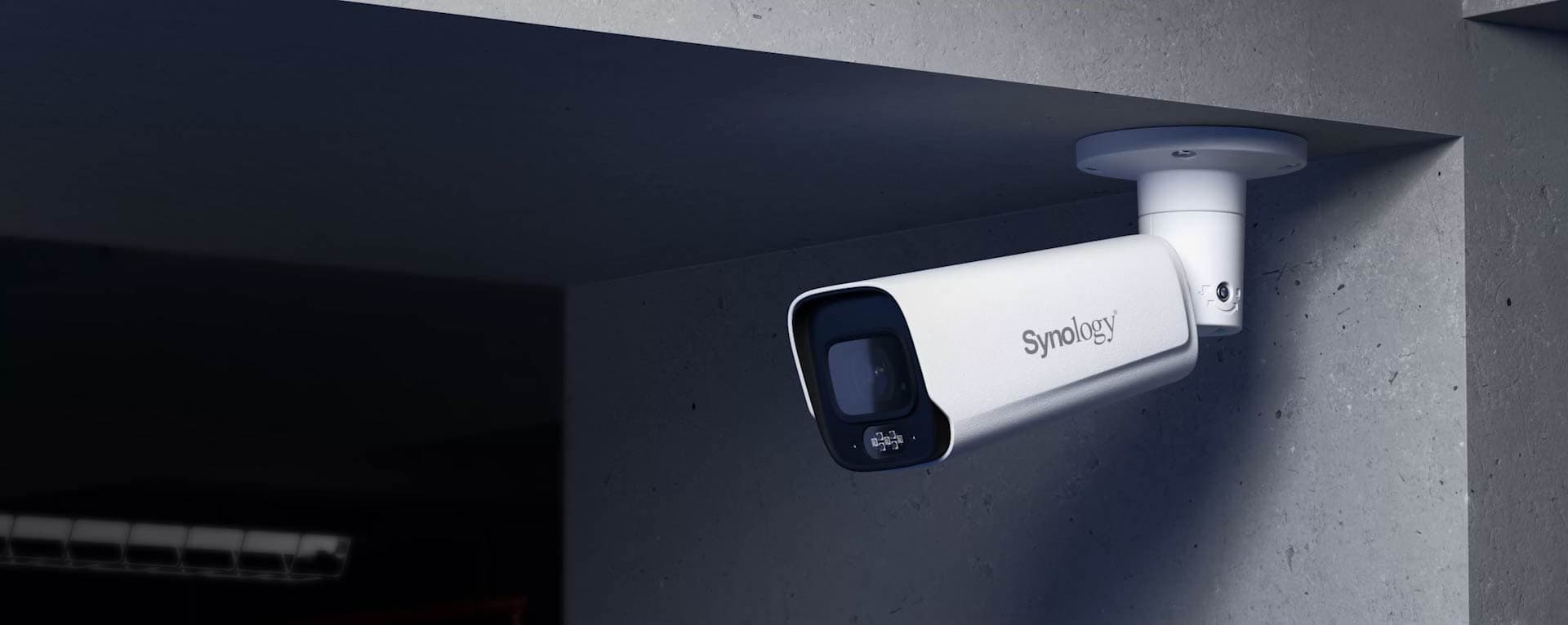 Synology BC800Z bullet camera installed under a concrete soffit on its ceiling mount - manufacturer in-situ image from the Synology BC800Z product page