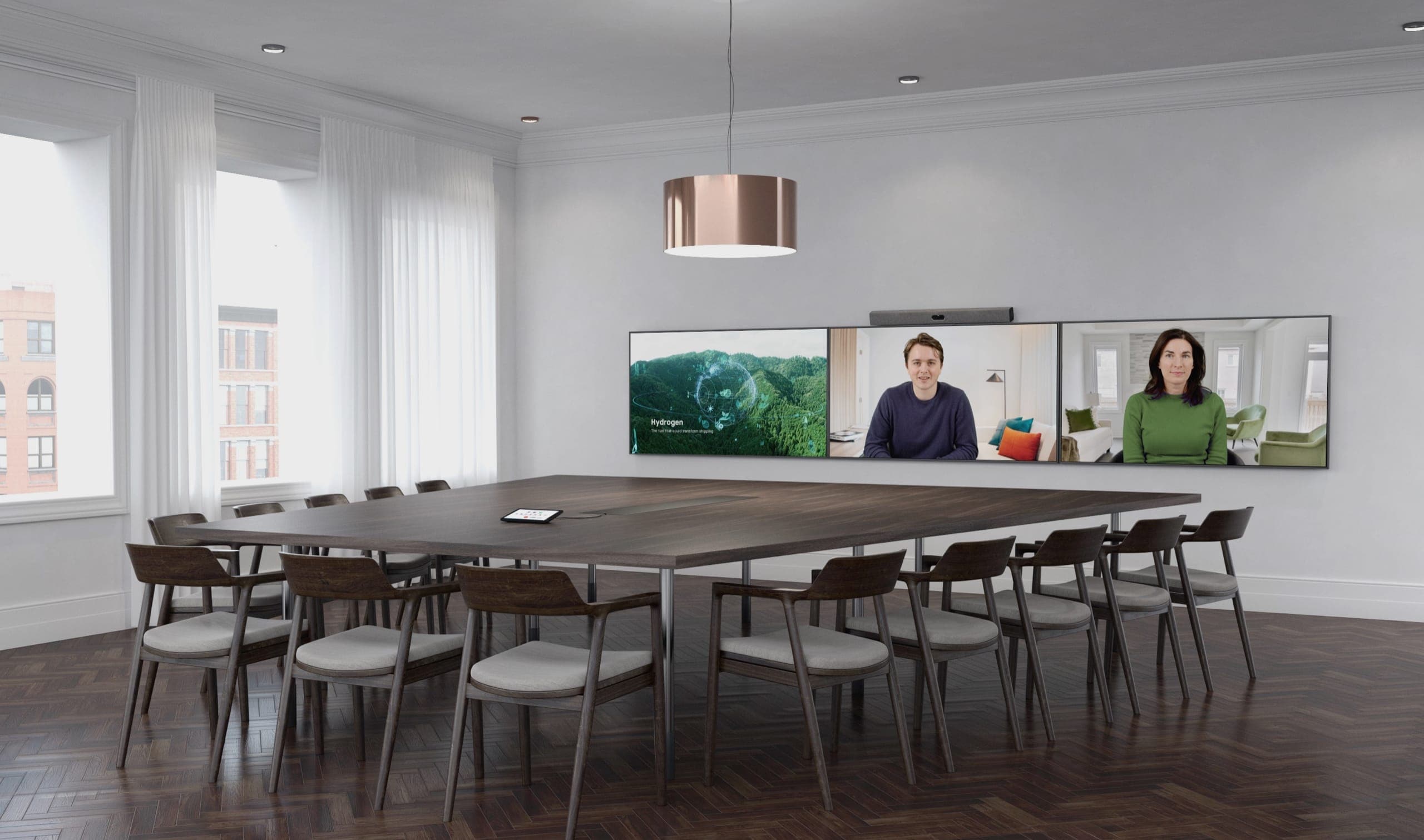 Neat Bar Pro mounted above a three-screen wall in a large boardroom with a Neat Pad on the table - in-situ scene; the screens, mount, table and room are not included