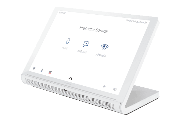 Front-left view of the white Crestron TS-1070-W-S tabletop touch screen on its integral stand, showing a source-selection screen.