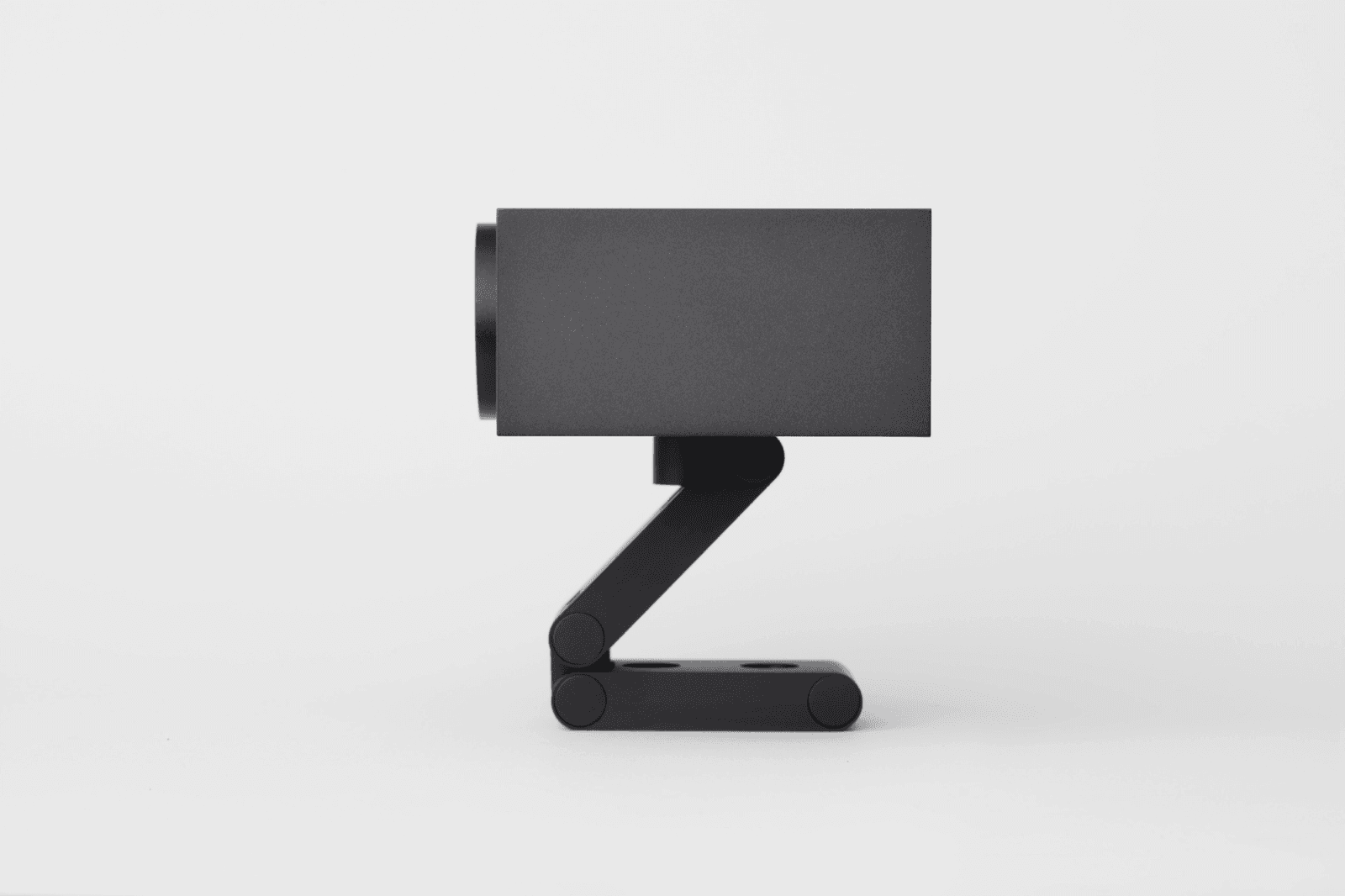 Huddly S1 conference camera on its included wall and shelf mount